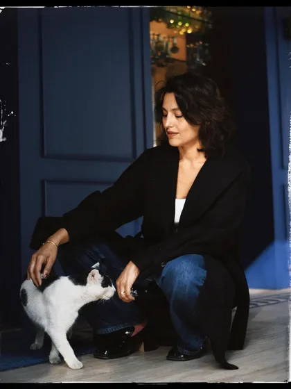 A candid moment between Priya and a friendly cat. The black and white with a film-like border gives it a timeless, storybook feel.