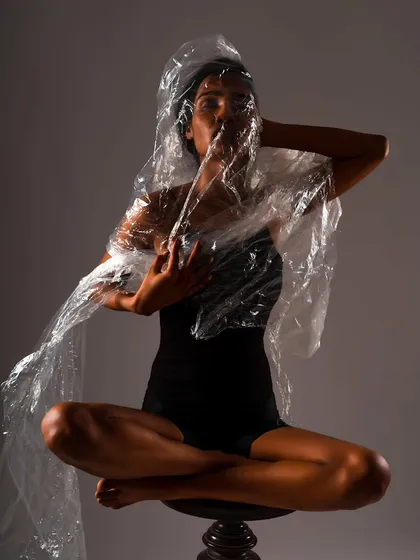 An artistic image from my conceptual portrait series, "UNRAVEL". I use props like this plastic wrap and focused lighting to explore themes and create fine art photographs that are both visually compelling and thought-provoking.