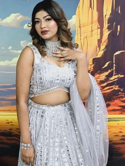 A beautiful mirror-work lehenga in a light grey color. This outfit is perfect for creating a chic and modern look for a day event.