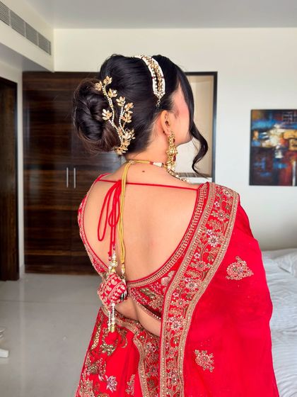 A close-up of the stunning hairstyle, featuring a sleek bun adorned with a statement accessory.