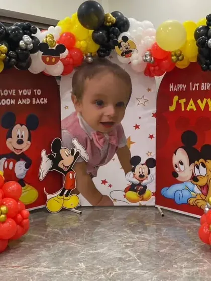 A classic Mickey Mouse theme for Stavya's first birthday, using the iconic red, yellow, and black color scheme.