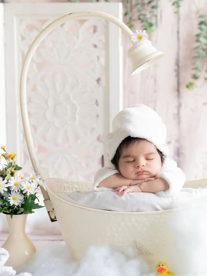 Soaking in the calm. This little one is enjoying a peaceful moment in our miniature bathtub prop, surrounded by daisies.