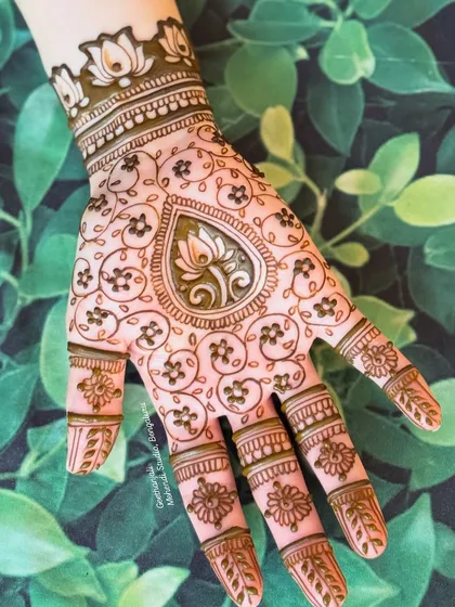 A close-up of the minimal teardrop lotus design, showing the fine lines and dot work.