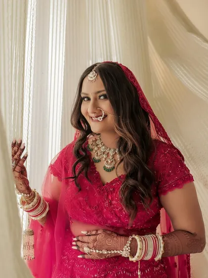 A beautiful, happy portrait of the bride in her red wedding attire. Her smile says it all, and the makeup is there to enhance that natural radiance without overpowering her features.