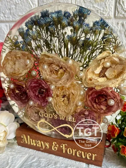 A close-up of the block, highlighting the "God's Will" text and infinity symbol among the preserved flowers.