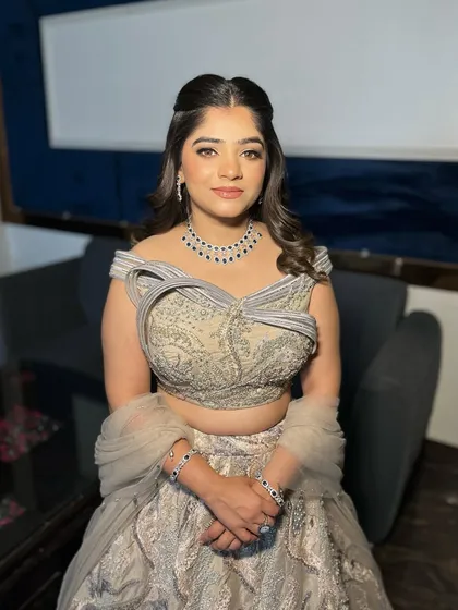 A full portrait of Jaya's engagement look. The cool-toned makeup perfectly complements her silver and blue lehenga.
