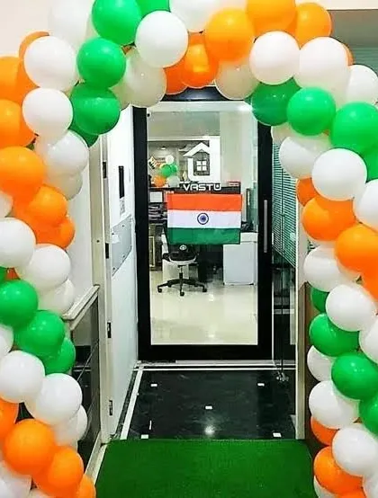 A tricolor balloon arch is a simple yet effective way to decorate an office entrance for Independence Day. This setup uses saffron, white, and green balloons to frame the doorway, creating a festive welcome for employees and visitors.