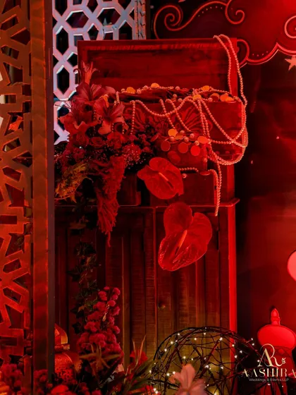 A close-up of a treasure chest, overflowing with faux gold coins and pearl strings, adding to the Arabian Nights theme.