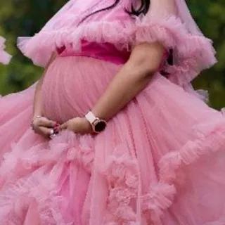 A close-up showing the delicate layers and soft texture of the pink ruffled tulle. Every detail is designed to make you feel special during your maternity session.