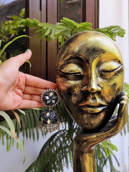 This black oxidised jhumka with mirror work is a gorgeous, lightweight option for any festive occasion.