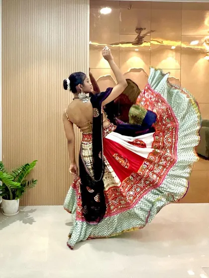 A graceful spin captured in a photo. You can see the movement in the skirt and the elegance of the backless choli design.