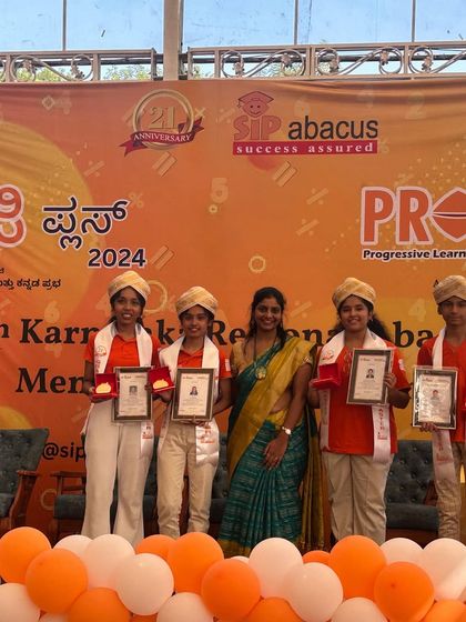 Our students and their teacher celebrating their graduation and achievements together. This bond between teacher and student is at the heart of our success.