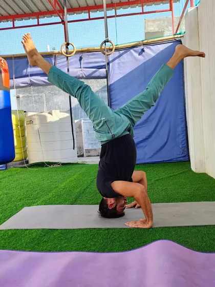 The headstand, or Sirsasana, is called the king of all asanas. It looks hard, but I teach it step by step. This variation with split legs helps open the hips while building core and shoulder strength.
