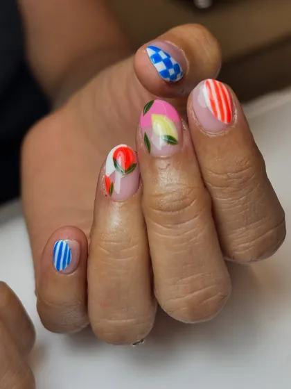 Another view of the fun, fruity nail art, showing the mix of patterns and colors. This kind of "mismatched" but coordinated art is super trendy and expressive.