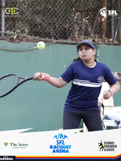 A young female player executes a powerful forehand during a match. We are committed to developing strong female athletes and providing a supportive training environment.
