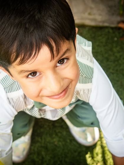 A fun, low-angle shot of the birthday boy playing with a balloon. This perspective adds a dynamic and playful feel to the party photos.