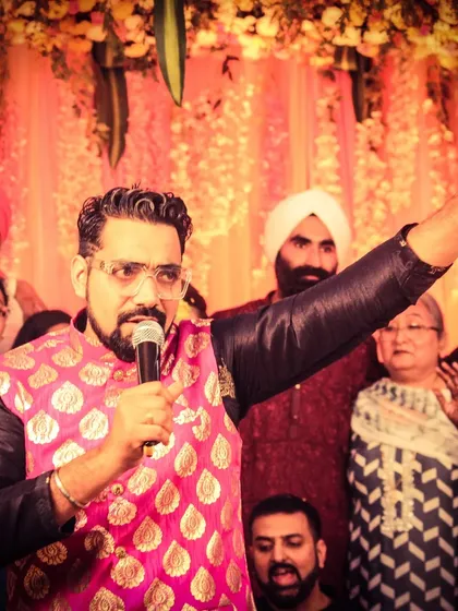 In the middle of the crowd, making sure everyone feels like part of the celebration. This photo captures me engaging with guests during a lively family event, dressed in a vibrant pink jacket.