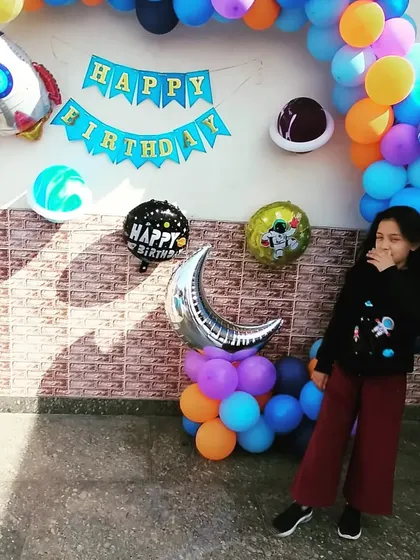 A candid moment from the space-themed birthday party. Our goal is to create a backdrop so cool that it becomes the highlight of the party photos.