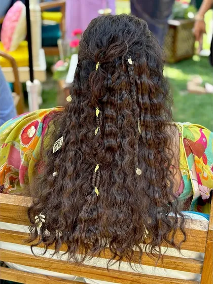 The hairstyle was a major part of this look. We went for a bohemian vibe with crimped hair, braids, and delicate leaf-shaped accessories.