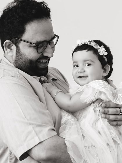 A black and white version of the father and daughter portrait. The classic feel of monochrome adds a timeless quality to this heartwarming moment.