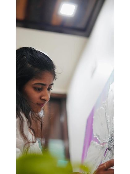 A quiet moment of focus while working on a textured floral canvas. The process is meditative, allowing me to pour my emotions directly onto the canvas.