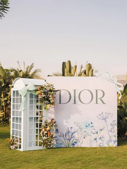 It's all in the details. For a chic Dior-inspired birthday, I designed and built this elegant telephone booth, adorned with soft florals. It’s a perfect example of how a unique, bespoke prop can elevate a theme and create a charming photo opportunity.