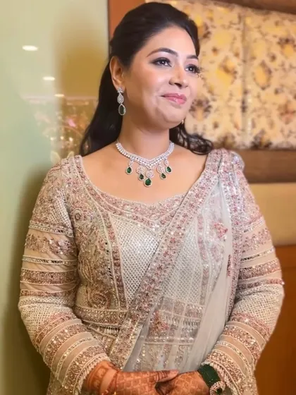 A candid shot capturing the bride's natural smile and radiant glow. The makeup is soft and dewy, enhancing her features for a look that is both glamorous and approachable.