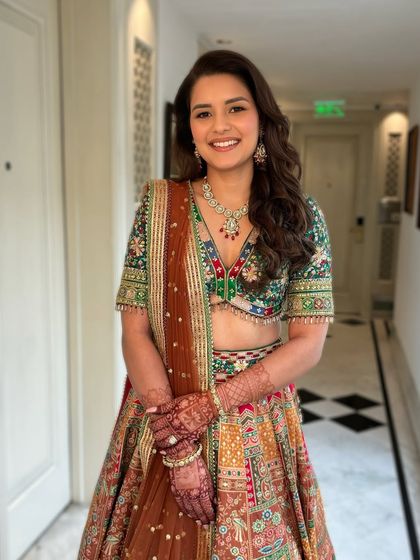 Tripti for her Mehendi. Her multi-colored lehenga was so vibrant, so we kept the makeup fresh and glowing with a soft lip.