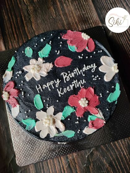 I love when simple bento cake designs translate to bigger cakes. This black cake with painted buttercream flowers has a beautiful, moody, and artistic feel.