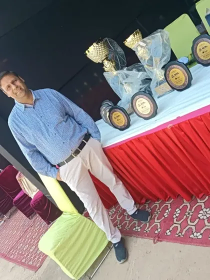 At the SCPL Jr. cricket tournament, standing by the awards. My role is to ensure players are fit to compete, providing everything from pre-game warm-ups to post-game recovery.