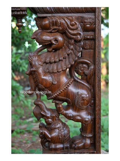 Another angle of the Yaali bracket, showing the fine lines and textures carved into the wood to depict the creature's mane and muscles.