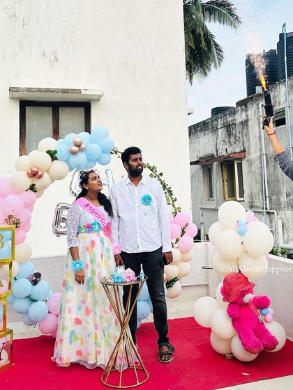 The parents-to-be enjoying the gender reveal moment during their surprise baby shower on the terrace.