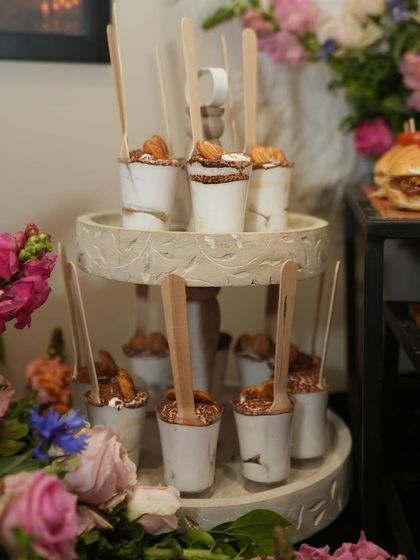 Individual dessert cups served on a beautiful two-tiered stand. These treats were part of the elegant spread for the Bhawna Rao luxury launch event.