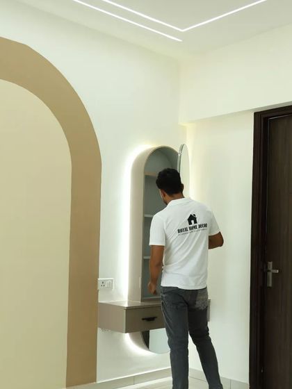 A compact dressing unit with an arched mirror and integrated lighting, making smart use of a small corner.