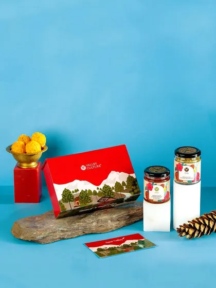 A clean and simple festive composition for Valley Culture's gift set against a cool blue background. This shows versatility in styling for different festive aesthetics.