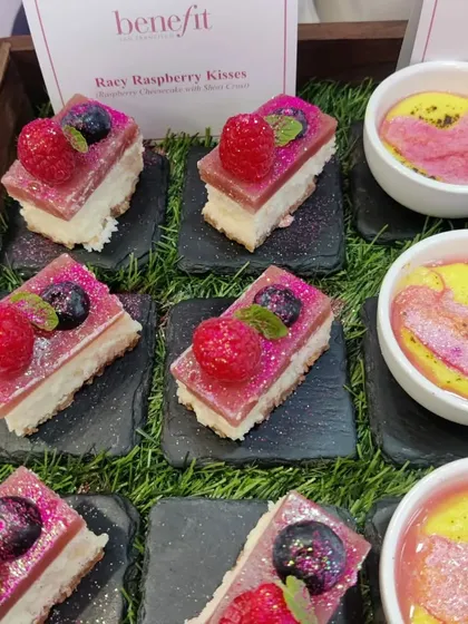 "Racy Raspberry Kisses," a raspberry cheesecake dome dessert we created for a Benefit Cosmetics event. Our themed desserts are designed to be as visually appealing as they are delicious.