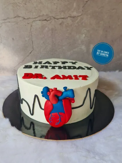 A cake for a cardiologist, the one who keeps our hearts ticking. This design features a fondant anatomical heart and an EKG heartbeat line, a sweet and clever tribute to a doctor's life-saving work.