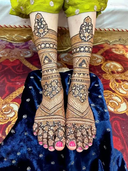 A close-up of a symmetrical feet design with geometric and floral patterns. The dark stain and clean lines ensure the design looks sharp and beautiful.