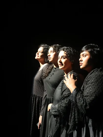 The simmering tension within "The House of Bernarda Alba." This powerful shot captures the all-women cast in a moment of quiet defiance, showcasing the dramatic lighting and ensemble acting that define our productions.
