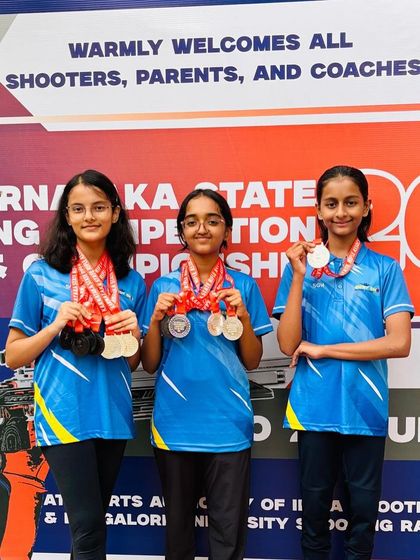 Three of our top women air rifle shooters, Indu, Bhuumika, and Sanvi, celebrating their collective success and medal haul at a state competition.