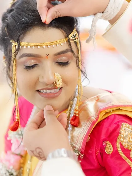 A tender moment where the groom blesses the bride. Her soft, natural makeup is perfect for this close-up shot.