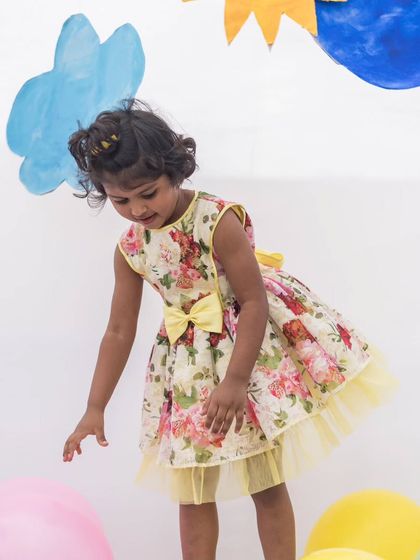 This little one is ready for a sunny day in her yellow floral dress. The simple design lets the vibrant print be the star of the show.
