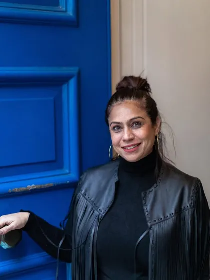 The vibrant blue door adds a pop of color and joy. This photo captures a simple, happy moment during a city walk, a reminder to find beauty in the everyday.