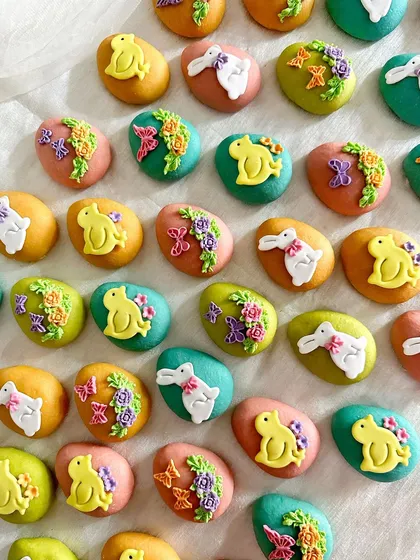 I make my marzipan eggs in a variety of pastel shades, each decorated with unique Easter-themed designs like bunnies and floral patterns.