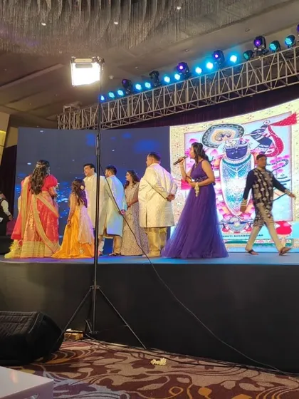 On stage at a grand sangeet celebration. My experience with large-scale social events means I'm comfortable commanding a big stage and managing the flow for hundreds of guests, a skill I bring to corporate galas too.