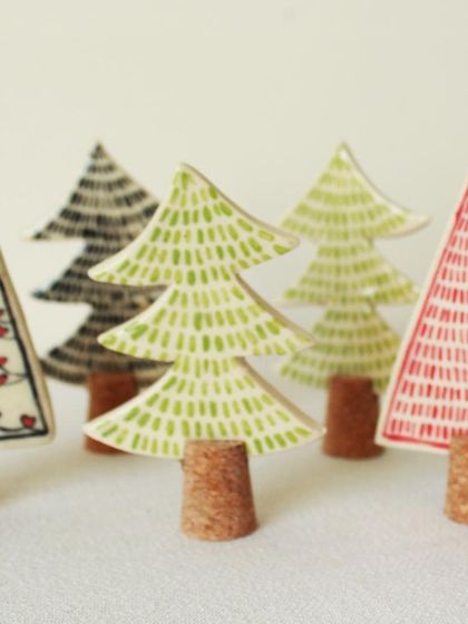 A small forest of my hand-painted ceramic trees with cork trunks. Each one has a unique pattern, from tiny hearts to simple dashes and lines.