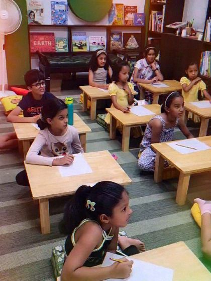 Kids deeply engaged in learning the basics of doodling. Our workshops are a space for children to express themselves freely without worrying about the outcome.