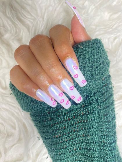 A close-up of a Valentine's set with a beautiful iridescent base and delicate pink heart outlines. The long, square shape and glossy finish make this design pop.