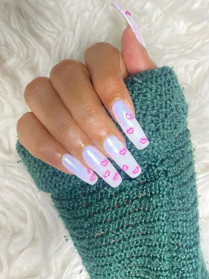 A dreamy Valentine's set with long, square nails. The iridescent white base is decorated with delicate, hand-painted pink hearts for a soft and lovely look.
