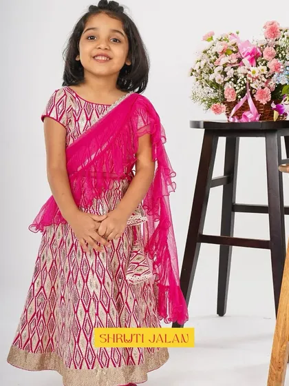 A full-length view of this stunning pink printed lehenga with a ruffled dupatta. It's a perfect blend of traditional print and modern silhouette.